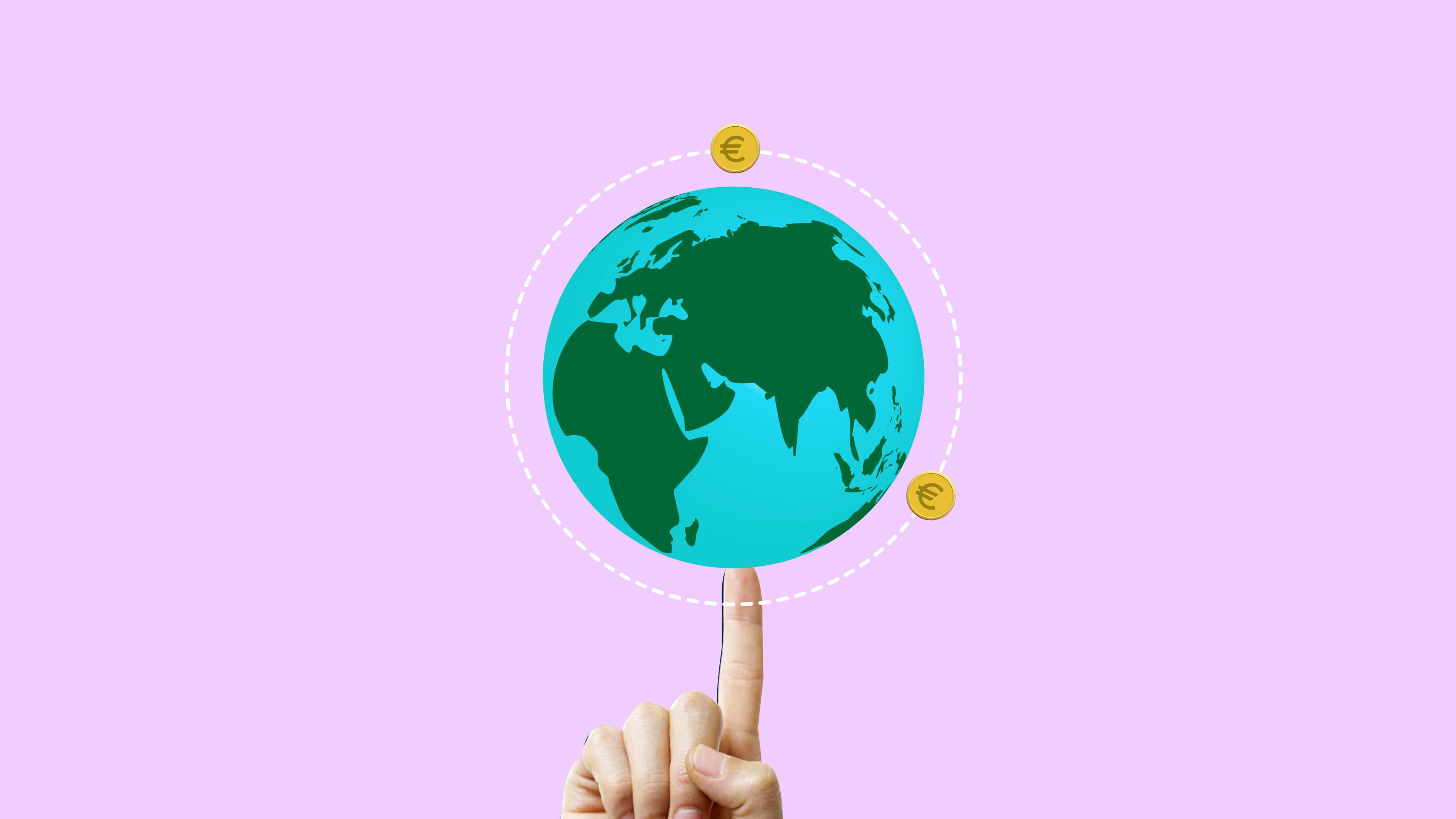 Hand balancing Earth with Euro symbols, illustrating global economy