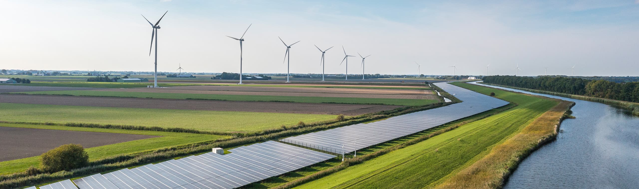 solar panels and wind powerplants on the green fields