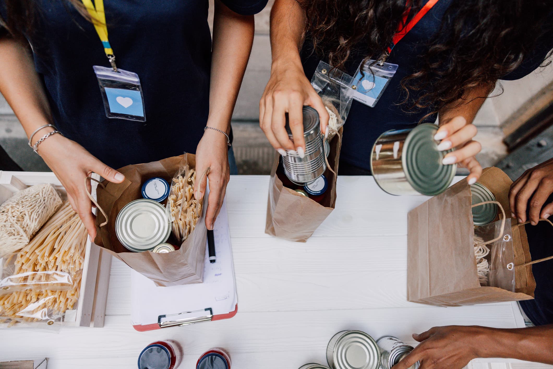 Closeup of peoples hands packing food supplies into the boxes - Policy Lab Study Shapes Luxembourg’s Anti-Racism Plan - Hero image