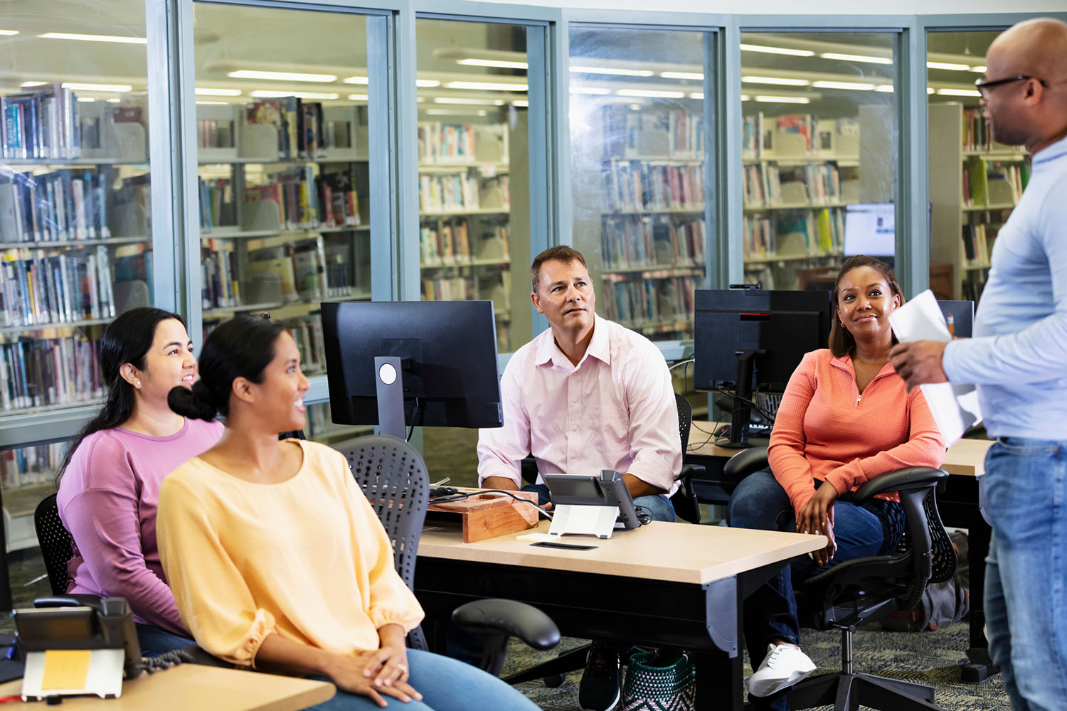 Adult students, teacher in continuing education class
